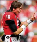  ?? CURTIS COMPTON/CURTIS.COMPTON@AJC.COM ?? JT Daniels, who did not play Saturday, offers help from the sideline. “JT is frustrated (by his injuries),” coach Kirby Smart said.