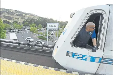  ?? JOSE CARLOS FAJARDO — STAFF PHOTOGRAPH­ER ?? A BART train operator looks out a window while stopping at the Orinda BART station Thursday. State lawmakers could begin discussion of a bill today allowing the building of housing on BART parking lots.