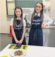  ?? ?? Fry and dry Calderside pupils Hayley Stewart and Ava McNeil caught the judges’attention with their spicy beef stir fry