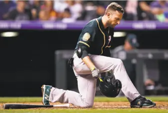  ?? David Zalubowski / Associated Press ?? Jed Lowrie, striking out in the fifth inning, and the A’s were held in check again at Coors Field.