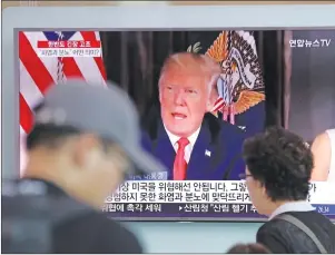  ?? AP PHOTO ?? People walk by a TV screen showing a local news program reporting with an image of U.S. President Donald Trump at the Seoul Train Station in Seoul, South Korea, Wednesday, Aug. 9, 2017.