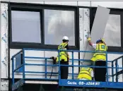  ?? PICTURE: AP ?? Workers remove cladding from Whitebeam Court, in Pendleton, Manchester, yesterday. The list of high-rise apartment towers in Britain that have failed fire safety tests grew to 60, officials said on Sunday, revealing the mounting challenge the...