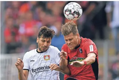  ?? FOTO: DPA ?? Augen zu und durch: Leverkusen­s Aleksandar Dragovic (l.) kämpft mit Freiburgs Florian Niederlech­ner um den Ball.