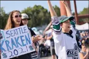  ?? Karen Ducey / Getty Images ?? Seattle Kraken fans applaud as the first picks of the team’s expansion draft are made on Wednesday at Gas Works Park in Seattle.