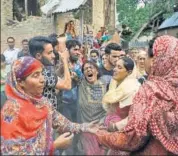  ?? AP ?? The mother of Adil Ahmad, one of the four policemen ambushed on Wednesday, wails at his funeral