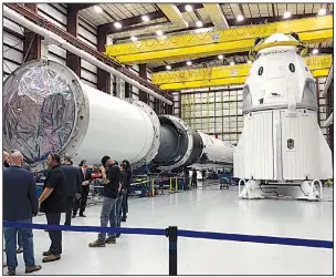  ?? AP/MARCIA DUNN ?? SpaceX’s Dragon capsule (right) sits in a SpaceX hangar in Cape Canaveral, Fla., in December.