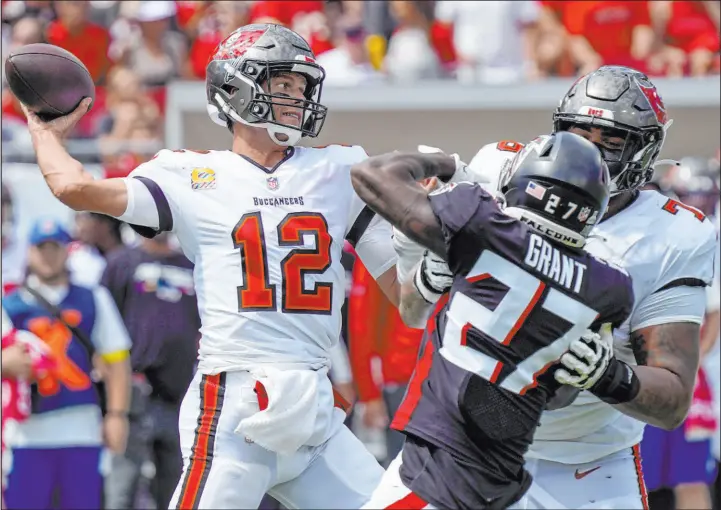  ?? Chris O’meara The Associated Press ?? Buccaneers quarterbac­k Tom Brady was the beneficiar­y of a late game roughing the passer call against the Falcons that was widely criticized.