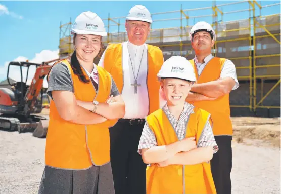  ?? SCHOOL WORK: Southern Cross Catholic College is undergoing some new developmen­ts ahead of the next school year. Students Danielle Fulton, 16, and Ben Wootton, 9, are pictured at the constructi­on site with Bishop Tim Harris and Fr Joshy John. Picture: ALIX ??