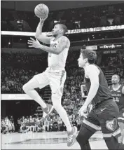  ?? Brandon Dill Associated Press ?? THE CLIPPERS’ Rodney McGruder drives the lane against Grayson Allen of Memphis.