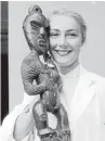  ?? Photo: ALEXANDER TURNBULL LIBRARY REF: EP/1959/0933-F ?? A museum worker with a Maori meeting house carving, or tekoteko, in 1959.