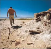  ?? Mark Boster Los Angeles Times ?? JON KLUSMIRE, amuseum administra­tor, takes a walk near the Owens Lake bed. The DWP floods part of the lake bed regularly to control dust.