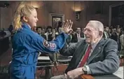  ?? Jacquelyn Martin Associated Press ?? AMELIA GILLESPIE, 9, greets Apollo 11 mission director Eugene Kranz before a Senate hearing.