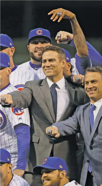  ?? GETTY IMAGES ?? Theo Epstein and Jed Hoyer show off their World Series rings on April 12, 2017, at Wrigley Field.