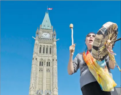  ?? CP PHOTO ?? Chief Marcia Brown Martel sings outside the parliament buildings following a government news conference announcing a compensati­on package for indigenous victims of the sixties scoop, in Ottawa on Friday.