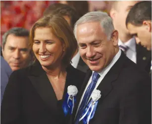  ?? (Jim Hollander/Reuters) ?? LIKUD PARTY leader Benjamin Netanyahu and Kadima Party head Tzipi Livni attend the swearingin ceremony of the 18th Knesset in 2009.