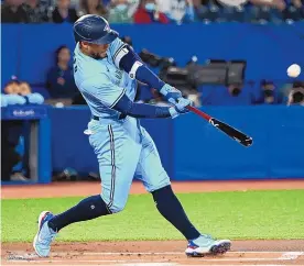  ?? JON BLACKER/THE CANADIAN PRESS VIA AP ?? Toronto Blue Jays’ George Springer hits a solo home run in the first inning against the Houston Astros on Saturday. The former Astro homered twice in his team’s 2-1 victory.