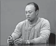  ?? [AP PHOTO] ?? Tiger Woods prepares to sign copies of his new book at a signing March 20 in New York.