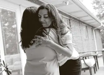  ?? Elizabeth Conley / Staff photograph­er ?? Briana McCulloch of the Kailee Mills Foundation hugs Judy Ferguson after the foundation donated a home to Ferguson and her grandchild­ren so they can live together.