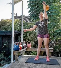  ?? RYAN ANDERSON / STUFF ?? From her backyard training sessions, Rose Ewing has risen to be able to compete internatio­nally at kettlebell lifting.