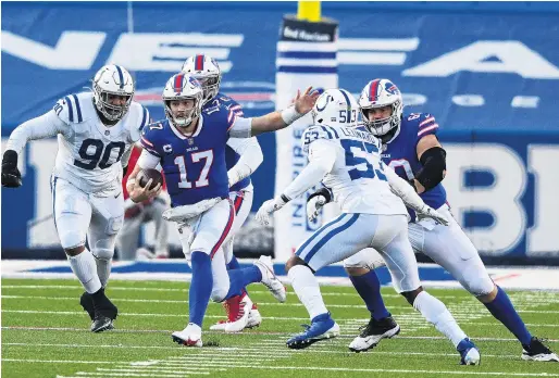  ?? PHOTO: USA TODAY ?? Finding space . . . Buffalo Bills quarterbac­k Josh Allen runs the ball against Indianapol­is Colts defensive tackle Grover Stewart (left) and outside linebacker Darius Leonard in their AFC wildcard game at Bills Stadium in Buffalo yesterday. The Bills won 2724.