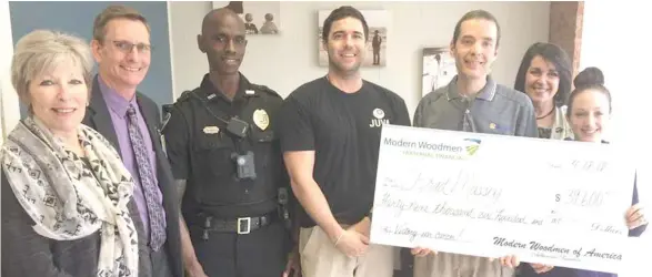  ?? (Submitted photo) ?? A check for $39,600 was presented to Brad Massey and his wife, Lindsey, to help with his medical expenses as the MSU detective battles stage-four colon cancer. Pictured, from left, Mayor Lynn Spruill, MSU Police Chief Vance Rice, Officer Alonzo Brooks,...