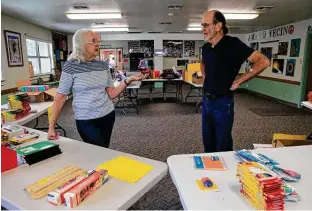  ?? ?? Rod and Patti Radle sort through donated school supplies on Aug. 15. Their organizati­on has establishe­d food and afterschoo­l programs. About 6,500 people benefit from their work each year.