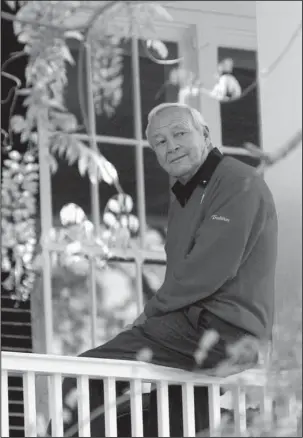  ?? The Associated Press ?? LONG LIVE THE KING: Arnold Palmer is pictured sitting on the clubhouse railing at the Augusta National Golf Club in 2004. Palmer, who died last year, won the Masters four times on the famed Georgia course. He is being honored this week at the PGA Tour...