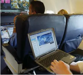  ?? AP PHOTO BY CHRIS ISON ?? This is a July 29, 2002 photo of a laptop is used on a plane. Britain’s government on Tuesday banned electronic devices in the carry-on bags of passengers traveling to the U.K. from six countries, following closely on a similar ban imposed by the...