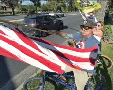  ?? Dan Watson/The Signal ?? (Above) Kevn and Terra Woodbury, of Saugus, join hundreds of attendees on Valencia Boulevard during a rally to reopen California and Santa Clarita on Tuesday. (Left) Marian Salazar expresses her views on the shutdown in response to COVID-19 during the rally.