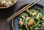  ?? MILK STREET ?? This image released by Milk Street shows a recipe for stir-fried chicken w/snap peas & basil.