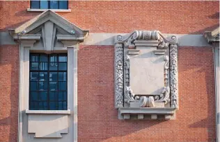  ??  ?? The building’s simple-cut, red-brick facade is graced by an exquisite stone carving. — Qiao Zhengyue