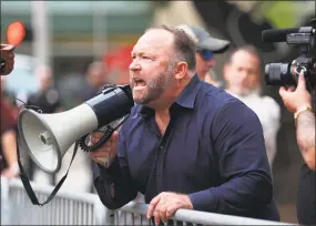  ?? Houston Chronicle file photo ?? Alex Jones, of InfoWars, yells at protestors outside of Toyota Center before a Trump campaign rally in October 2018 in Houston.