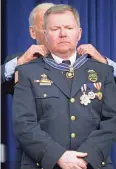  ?? ASSOCIATED PRESS ?? Vice President Joe Biden awards the Medal of Valor to Lt. Brian Murphy, from the Oak Creek Police Department Feb. 11, 2015, during a ceremony in the Old Executive Office Building on the White House Complex in Washington. Medals were awarded to public...