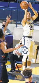  ?? PAULW. GILLESPIE/CAPITAL GAZETTE ?? Navy’s Cam Davis lets fly with a 3-point shot Saturday against Bucknell. Davis scored 19 of his 26 points in the second half to lead a Midshipmen comeback at Alumni Hall.