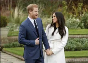  ?? MATT DUNHAM — THE ASSOCIATED PRESS FILE ?? In this file photo dated Monday Britain’s Prince Harry and fiancee Meghan Markle pose for photograph­ers during a photocall in the grounds of Kensington Palace in London, marking the couple’s engagement to marry.