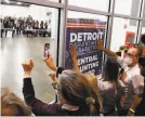  ?? Jeff Kowalsky / AFP via Getty Images ?? Supporters of President Trump bang on windows and chant slogans such as “Stop the count!” outside the room where absentee ballots are being counted Thursday in Detroit.