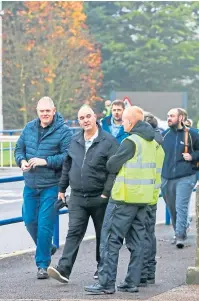  ?? Picture: Steve Brown. ?? Left: Staff leave the Michelin factory after the closure announceme­nt last year; The Courier’s front page after the story broke.