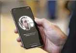  ?? ERIC RISBERG / AP ?? An Apple employee demonstrat­es the facial recognitio­n feature of the iPhone X at the Apple Union Square store in San Francisco.