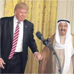  ?? Picture: Getty Images. ?? US President Donald Trump and Amir Sabah al-Ahmad al-Jaber al-Sabah of Kuwait hold hands as they arrive at a joint news conference in the East Room of the White House. Trump’s son has given more informatio­n on exchanges he had regarding informatio­n...