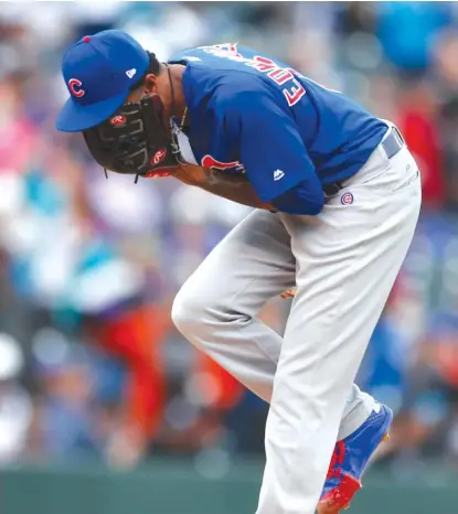  ??  ?? Reliever Carl Edwards Jr. yells into his glove after giving up a two- run single to Rockies pitcher German Marquez. | JACK DEMPSEY/ AP