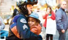 ?? JOHNNY NGUYEN/THE OREGONIAN FILE PHOTO ?? Sgt. Bret Barnum and Devonte Hart embrace during a Black Lives Matter protest in Portland, Ore.