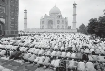  ??  ?? Muslims pray at Shahi Masjid at the Taj Mahal. Emperor Shah Jahan had the Taj Mahal built between 1632 and 1654 for his favourite wife after her death.