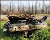  ?? ?? A scorched car rests July 4 in the yard of a home destroyed by a wildfire in the East Prairie Metis Settlement.