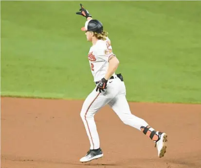  ?? MITCHELL LAYTON/GETTY ?? Orioles third baseman Gunnar Henderson runs the bases after hitting a two-run home run in the seventh inning Tuesday against the Detroit Tigers at Camden Yards. His blast would provide Baltimore’s only runs in a 3-2 loss.