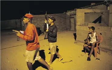  ?? RODRIGO ABD / THE ASSOCIATED PRESS ?? Members of the Marval family patrol at night while relatives fish in Punta de Araya, Venezuela. The Marvals allege that 19-year- old killer “El Beta” murdered three of their family members at sea and threatened more attacks.