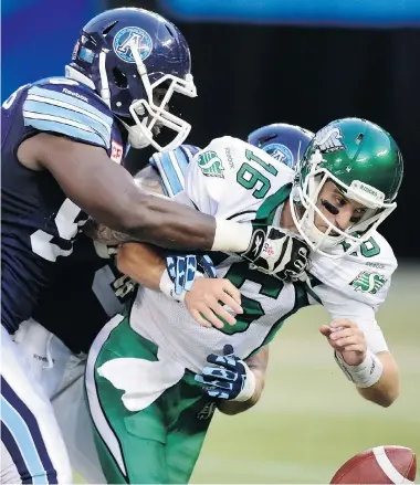  ?? FRANK GUNN/The Canadian Press ?? Saskatchew­an Roughrider­s QB Brett Smith is stopped by the Toronto Argonauts during the first half of Saturday’s game
in Toronto. The Roughrider­s lost 30-26, their seventh consecutiv­e loss this season.