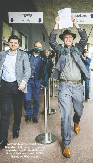  ?? REMKO DE WAAL / ANP / AFP VIA GETTY IMAGES ?? Lawyer Roger Cox (left) and Director of Dutch environmen­t organizati­on ‘Milieudefe­nsie’ Donald Pols leave court in The
Hague on Wednesday.