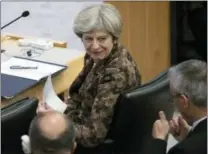  ?? MARY ALTAFFER — THE ASSOCIATED PRESS ?? British Prime Minister Theresa May speaks to an aide during a high level meeting on the situation in Libya on Wednesday at United Nations headquarte­rs.
