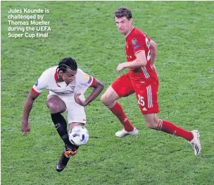  ??  ?? Jules Kounde is challenged by Thomas Mueller during the UEFA Super Cup final