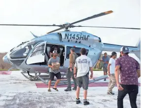  ?? PHOTO BY JILL TRUNNELL ?? Kenny Chesney’s Love for Love City team unloads supplies for victims of Hurricane Irma in St. John.